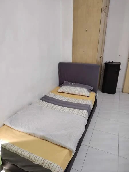 Bedroom features: single bed with mattress, grey bed frame, white bedding with patterned throw, yellow bedding, wooden wardrobe, white tiled flooring, plain white walls, black trash bin; style: minimalist.