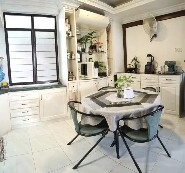 Dining features: round dining table with grey tablecloth, 4 black metal chairs with green cushions, white cabinetry, glass display cabinet with plants and kitchen items, white tiled flooring, ceiling fan, large window with black frames, decorative plants on the table; style: modern.