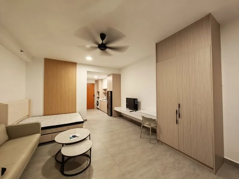 Living features: light grey tiled flooring, white painted walls, wood panel accent wall, 5-blade ceiling fan, sofa in light beige, round coffee table with black base, wall-mounted TV, built-in wardrobe with light wood finish, study desk with chair, refrigerator, open kitchen area; style: modern.