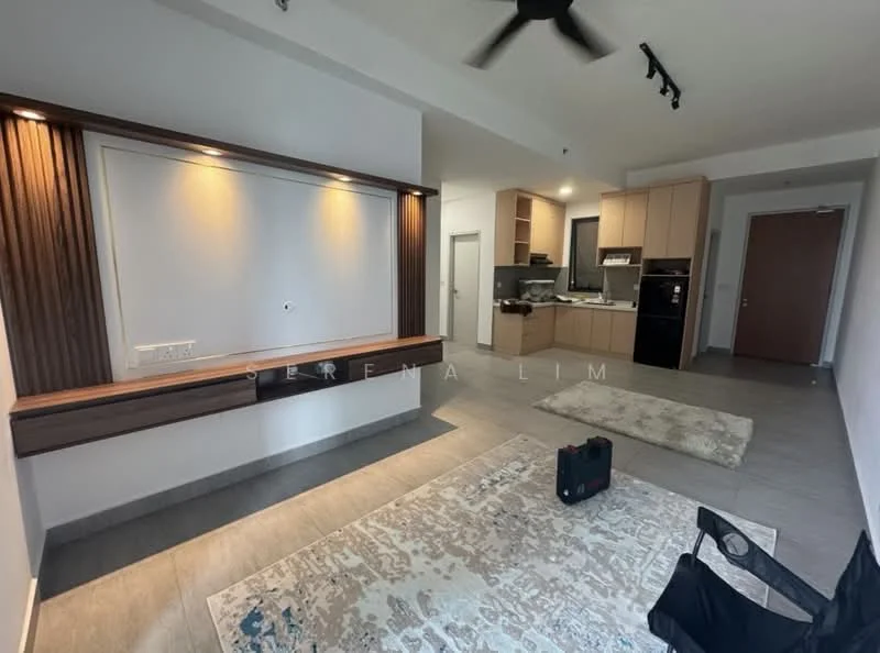 Living features: grey tiled flooring, white painted walls, wood feature wall with lighting, ceiling fan, recessed lighting, area rug with geometric pattern, wall-mounted TV console, open kitchen layout visible in background, kitchen cabinetry in light wood, stainless-steel appliances visible, doorway leading to other rooms; style: modern.