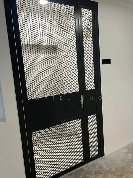 Room features: black metal security door with mesh, white painted walls, light fixture on ceiling, polished concrete flooring; style: modern.