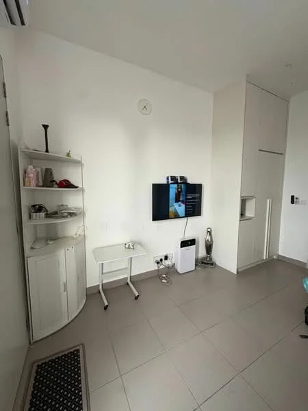 Living features: white painted walls, grey tiled flooring, wall-mounted TV, TV console, small white side table, white shelving unit, air conditioning unit, floor fan, doorway to another room, decorative items on shelves; style: modern.
