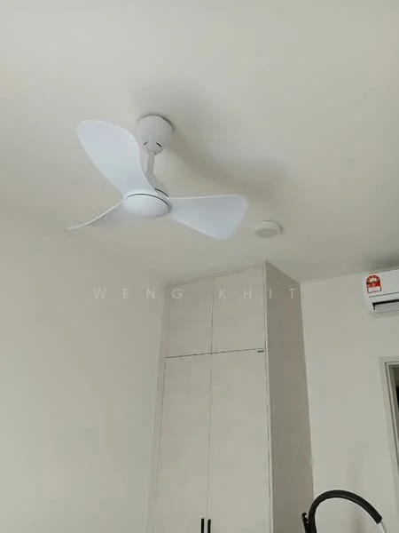 Room features: white painted walls, ceiling fan, wall-mounted split AC, built-in cabinets.