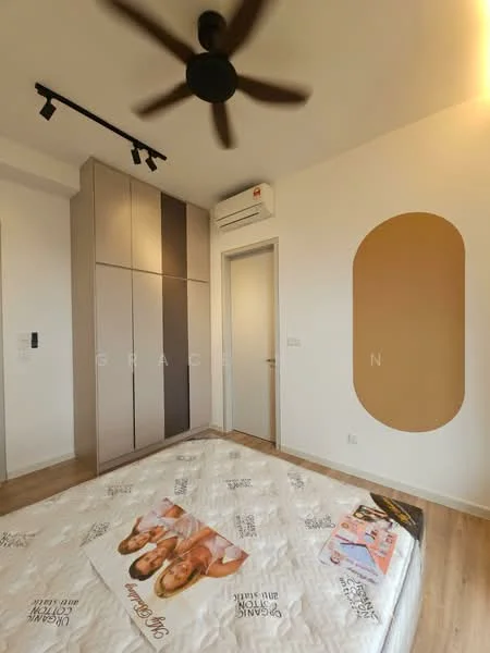 Bedroom features: queen-size bed with decorative bedding, built-in wardrobe with sliding doors in grey and beige, wooden flooring, ceiling fan with light, wall-mounted air conditioning unit, white painted walls, accent wall with oval shape in beige, door leading to hallway; style: modern.