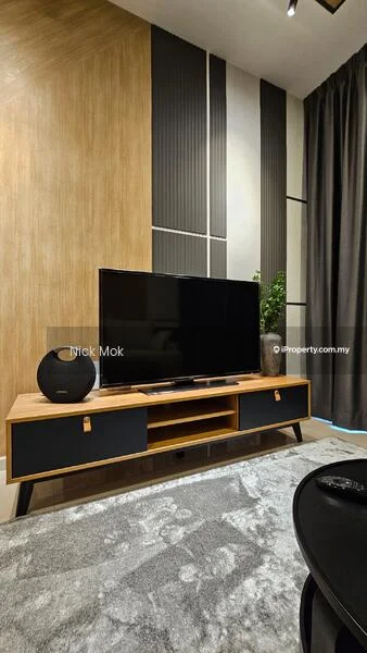 Living features: wood panel accent wall, grey wallpaper, black flat-screen TV, wooden TV console with black drawers, decorative plant, area rug with geometric pattern, recessed lighting, curtains, black chair; style: modern.