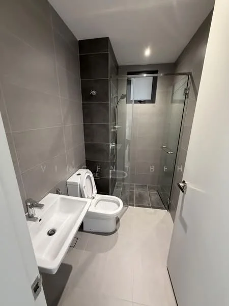 Bathroom features: grey tiled walls, white ceramic sink, chrome basin mixer faucet, white one-piece toilet, glass shower enclosure, rain shower head, handheld shower, grey tiled flooring, wall-mounted mirror, recessed lighting; style: modern.