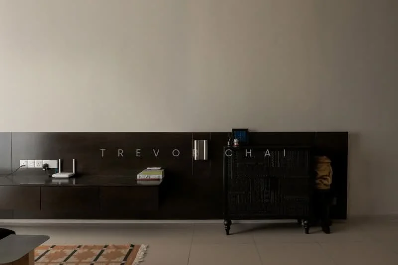 Room features: dark wood wall-mounted cabinet, black decorative cabinet, white wall, neutral tile flooring, decorative items on cabinet, books on cabinet, electrical outlets, small digital device on cabinet; style: modern.