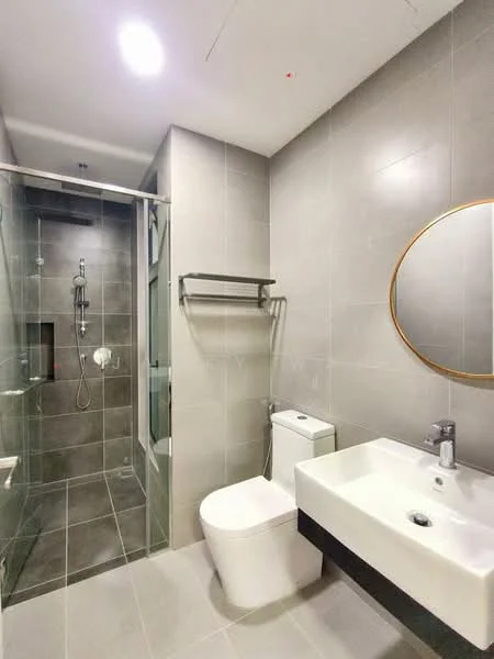 Bathroom features: grey ceramic tile flooring, grey tiled walls, walk-in shower with glass enclosure, rain shower head, handheld shower, single-sink vanity with wall-mounted cabinet, chrome basin mixer faucet, one-piece toilet, framed round mirror, towel rack; style: modern.