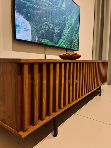 Living features: wooden TV console with slatted design, wall-mounted flat-screen TV, decorative bowl on console, light-colored wall, large window with sheer curtains, neutral-colored flooring, minimalist decor; style: modern.