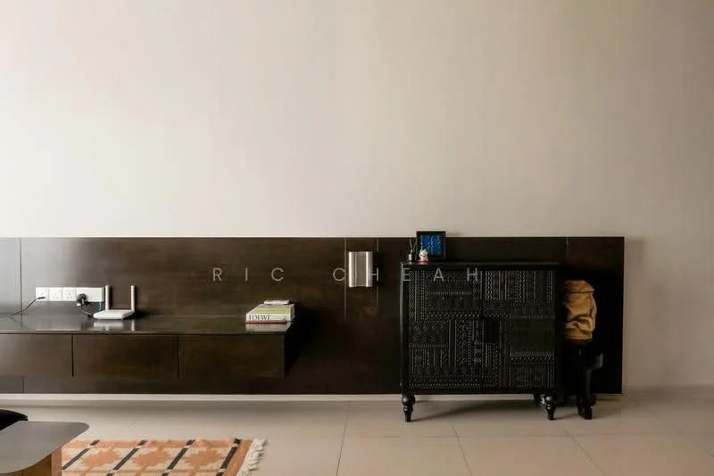 Room features: dark wood wall paneling, built-in wall shelf, decorative cabinet with intricate design, neutral wall color, light-colored flooring, area rug with geometric pattern, electrical outlets, decorative items on shelf; style: modern.