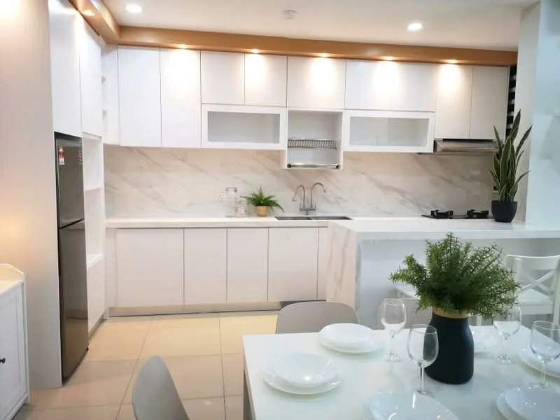 Kitchen features: white shaker cabinets, marble backsplash, stainless-steel fridge, double-bowl stainless-steel sink, chrome pull-down faucet, 4-burner gas hob, built-in oven, recessed downlights, light wood countertop, tile flooring, green potted plant, decorative plant on countertop; style: modern.