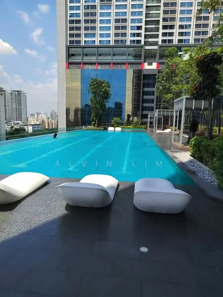 Exterior type: high-rise condominium; features: infinity pool, pool deck with loungers, glass curtain wall, surrounded by greenery, manicured landscaping, city skyline view; style: modern.