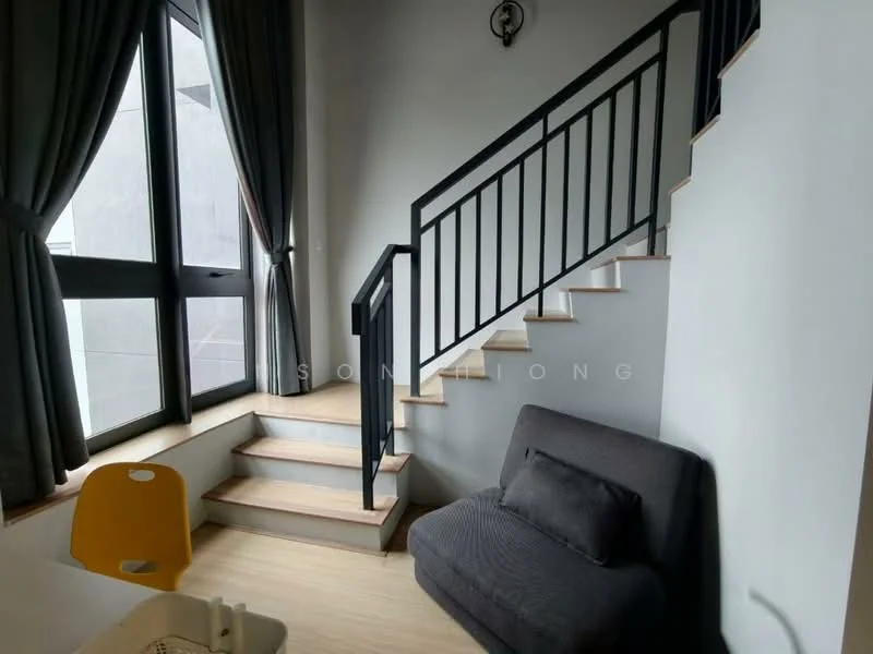 Room features: large windows, grey walls, wooden staircase, black metal railing, light wood flooring, grey fabric sofa, curtains, yellow plastic chair; style: modern.