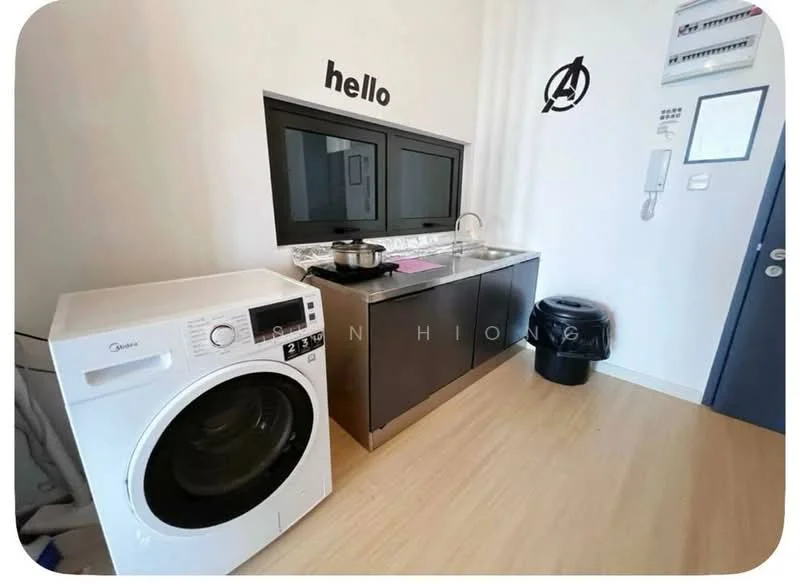 Laundry features: front-load washing machine, black cabinetry, white countertop, stainless-steel sink, chrome faucet, black trash bin, decorative wall art, light wood flooring; style: modern.