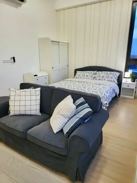 Bedroom features: queen-size bed with patterned bedding, upholstered headboard, 2 bedside tables, white dresser, grey fabric sofa, decorative cushions, laminate flooring, wall-mounted air conditioning unit, large window with city view, light-colored wall with vertical stripes, area rug; style: modern; view: city.
