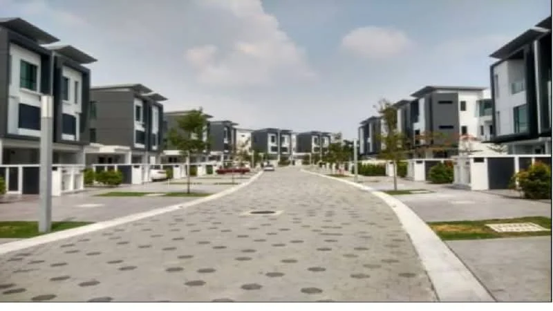 Exterior type: linked terrace house; features: modern facade with grey and white cladding, two-storey buildings, manicured landscaping, paved walkway with circular patterns, driveway with interlocking pavers, trees lining the street, fenced front yards, open-air parking spaces; style: modern.