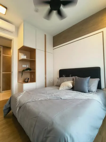 Bedroom features: king-size bed with grey bedding, upholstered headboard, 2 bedside pillows, ceiling fan, built-in wardrobe with white finish, wooden flooring, decorative wall paneling, shelf with decorative items, wall-mounted air conditioning unit, natural light from window; style: modern.