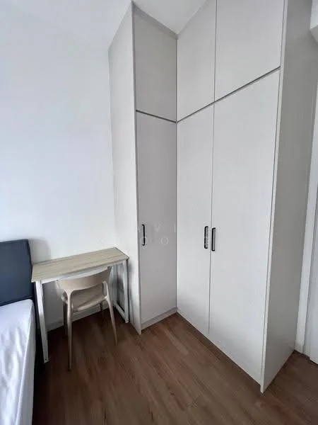 Room features: built-in wardrobe with sliding doors, light-colored cabinetry, wooden flooring, small study desk, single chair, white walls; style: modern.