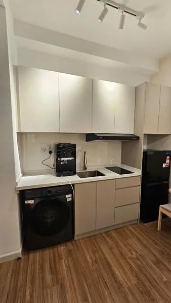 Kitchen features: light grey cabinetry, white countertop, single-bowl stainless-steel sink, chrome pull-down faucet, built-in oven, freestanding fridge, front-load washing machine, track lighting, wood laminate flooring; style: modern.