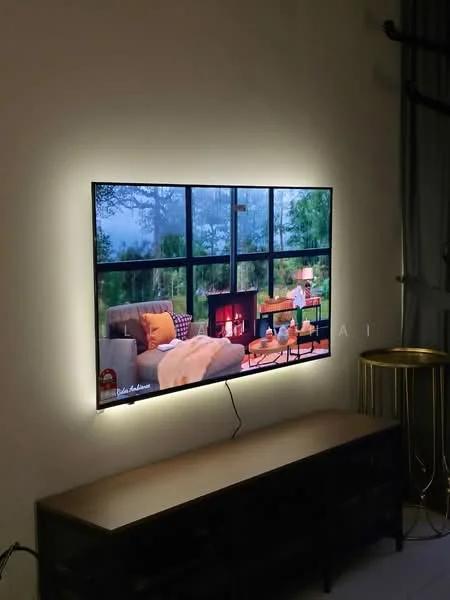 Living features: wall-mounted TV, sofa in beige, decorative throw blanket, coffee table, large windows with greenery view, side table, ambient lighting around TV, wooden console table; style: modern; view: garden.