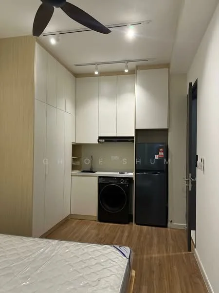 Room features: wooden flooring, white painted walls, ceiling fan, recessed downlights, built-in cabinetry in light wood, white upper cabinets, black countertop, stainless-steel sink, built-in oven, front-load washing machine, stainless-steel fridge, kitchen appliances visible; style: modern.
