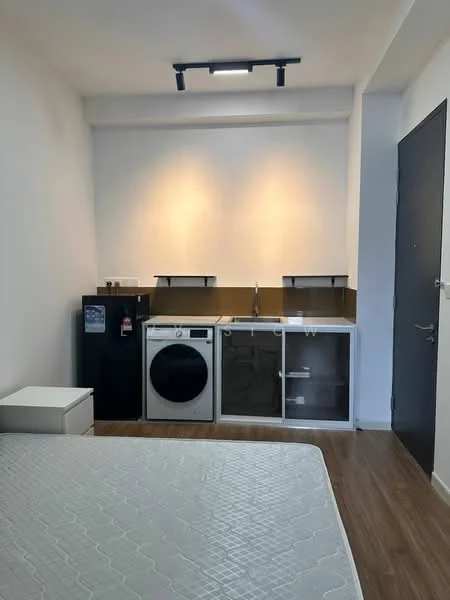 Room features: white painted walls, wood laminate flooring, recessed downlights, single-bowl stainless-steel sink, built-in cabinetry, washing machine, fridge, countertop, door with handle, mattress on bed frame; style: modern.