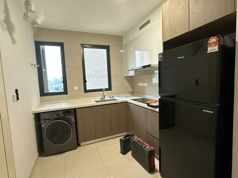 Kitchen features: white quartz countertop, brown wooden cabinetry, stainless-steel sink, chrome pull-down faucet, built-in oven, black refrigerator, front-load washing machine, ceramic tile flooring, two windows, wall-mounted cabinets, under-cabinet lighting; style: modern; view: city.