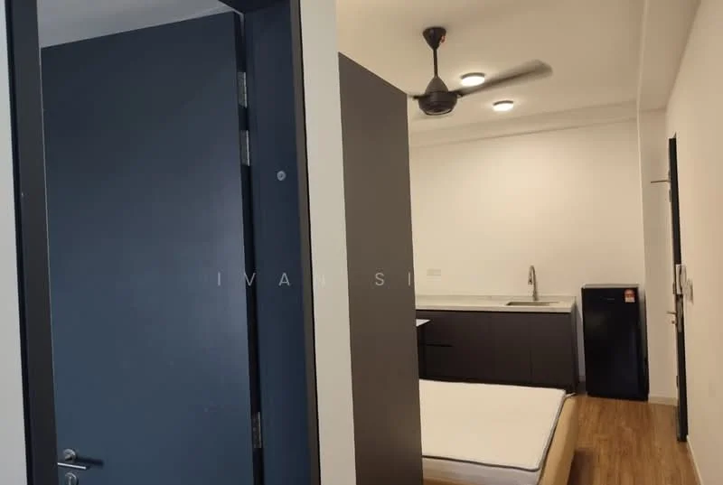 Room features: dark blue door, light wood flooring, white walls, ceiling fan, kitchenette with sink, black cabinetry, refrigerator, unmade bed with mattress; style: modern.