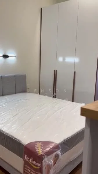 Bedroom features: queen-size bed, upholstered headboard, built-in wardrobe with sliding doors, light fixture on wall, neutral wall color, wooden flooring, mattress with protective cover; style: modern.