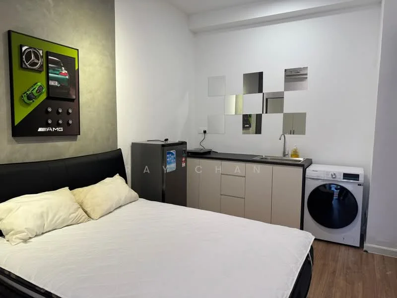 Room features: queen-size bed, black upholstered headboard, white bedding, grey accent wall, kitchenette with beige cabinetry, stainless-steel fridge, single-bowl stainless-steel sink, chrome faucet, washing machine, mirror wall decor, wall-mounted artwork, recessed lighting; style: modern.
