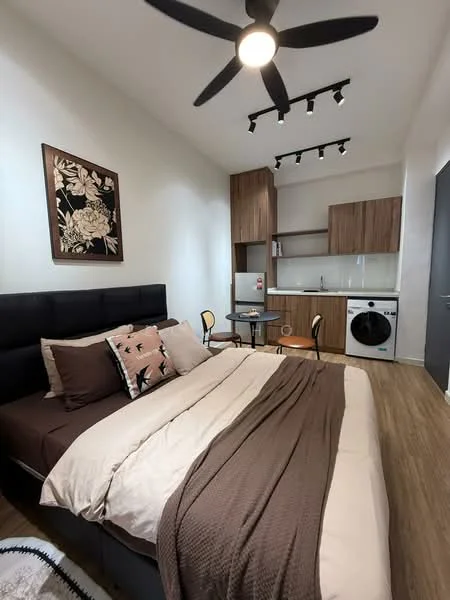 Bedroom features: king-size bed with brown bedding, upholstered headboard, 2 bedside chairs, wall-mounted artwork with floral design, wooden flooring, ceiling fan with 5 blades, recessed LED downlights, kitchenette with wooden cabinetry, stainless-steel fridge, front-load washing machine, small dining table, open shelving above kitchenette; style: modern.