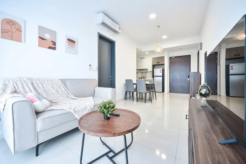 Living features: light grey fabric sofa, wooden coffee table, decorative plant on table, wall-mounted TV, TV console, recessed ceiling lights, air conditioning unit, white tiled flooring, framed artwork on walls, dining area visible in background, open layout to kitchen, dining table with chairs; style: modern.