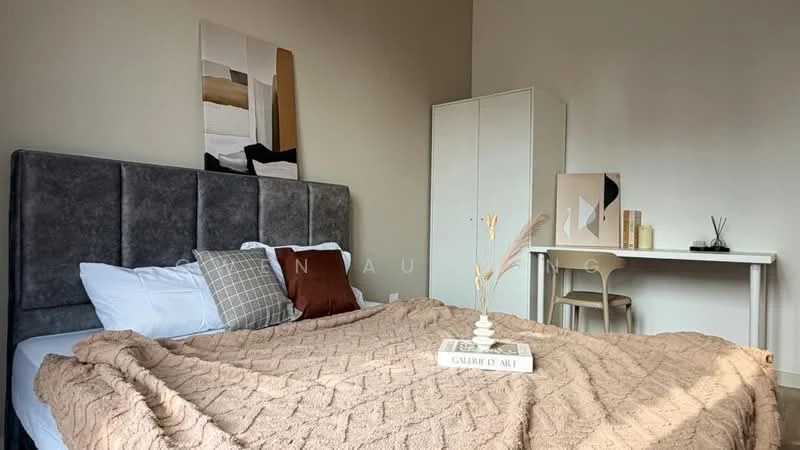 Bedroom features: king-size bed with upholstered headboard, beige knitted throw blanket, white bedding, decorative pillows in various colors, wooden study desk, white cabinet, framed artwork on wall, neutral wall color, flooring not visible; style: modern.