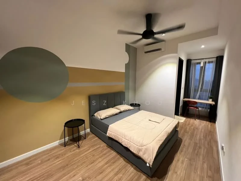Bedroom features: king-size bed, upholstered headboard, bedside table, ceiling fan, wooden flooring, painted accent wall with circular design, window with curtains, study desk with chair, wall-mounted air conditioning unit; style: modern; view: city.