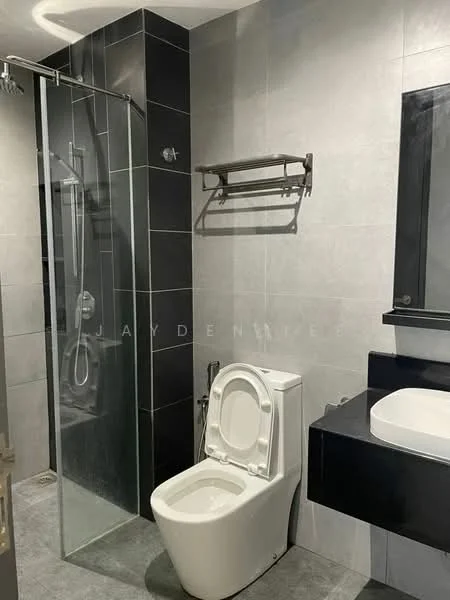 Bathroom features: walk-in shower with glass enclosure, chrome shower head, grey tile flooring, grey wall tiles, black countertop, single-sink vanity, one-piece toilet, towel rack, mirror above sink, recessed lighting; style: modern.