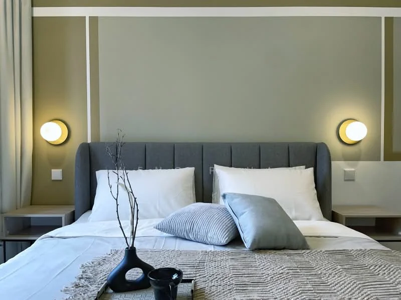 Bedroom features: king-size bed, upholstered headboard in grey, white bedding, decorative throw pillows in grey and blue, nightstands on either side, wall-mounted bedside lamps, green accent wall, white painted walls with decorative stripes, curtains in light fabric, decorative vase on nightstand; style: modern.