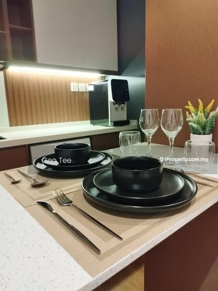 Kitchen features: white quartz countertop, brown cabinetry, black dinner plates, black bowls, cutlery set, wine glasses, decorative plant in pot, textured placemat, built-in kitchen appliances, under-cabinet lighting; style: modern.