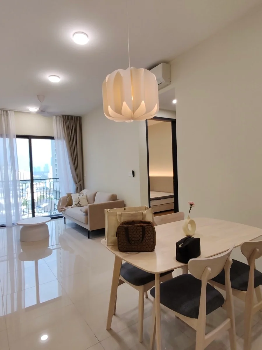 Living features: sofa in light beige, dining table with light wood finish, 4 dining chairs with grey upholstery, pendant lamp with floral design, floor-to-ceiling windows, curtains in light fabric, white painted walls, glossy tile flooring, ceiling lights, decorative vase on table, small decorative items on table; style: modern; view: city.