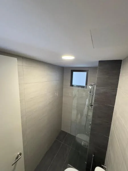 Bathroom features: grey tiled walls, light grey tiled flooring, walk-in shower with glass enclosure, chrome shower head, chrome handheld shower, single-sink vanity, white cabinet under sink, toilet, window for natural light, recessed ceiling lights; style: modern.