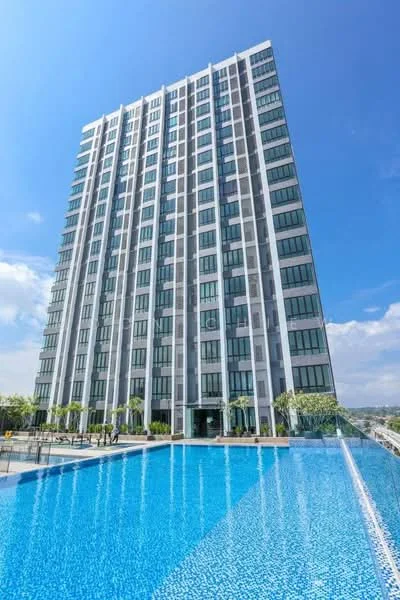 Exterior type: high-rise condominium; features: glass curtain wall facade, approximately 15-storey high-rise, infinity pool, pool deck with loungers, landscaped garden area, balconies on upper floors, surrounded by mature greenery, modern architectural design; style: modern.