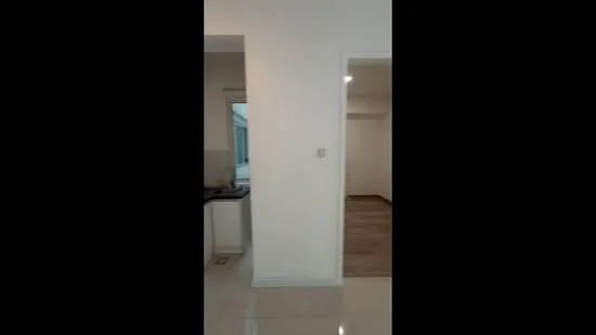 Room features: white painted walls, glossy tile flooring, window with natural light, doorway leading to another room, kitchen area visible, neutral color scheme; style: modern.