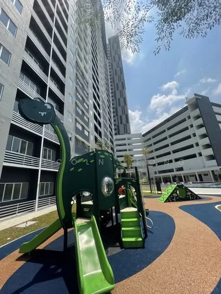 Exterior type: high-rise condominium; features: playground equipment, green slide, rubberized flooring, manicured lawn, surrounding high-rise buildings, parking deck, modern architecture, outdoor play area; style: modern.