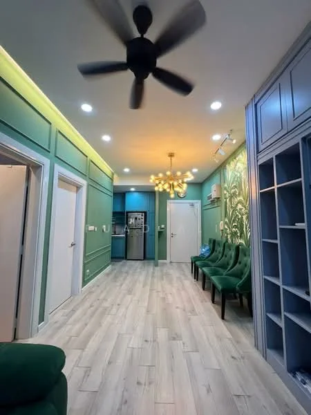 Living features: green painted walls, wooden flooring, 5-blade ceiling fan, chandelier with multiple bulbs, recessed LED downlights, built-in shelving unit, sofa in dark green, dining area with green upholstered chairs, open layout to kitchen, doorway to hallway, doorway to another room; style: modern.