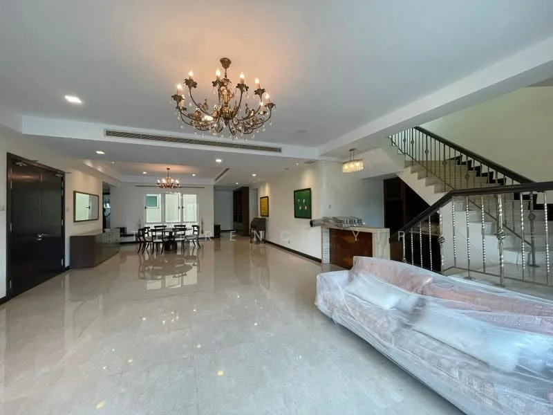 Living features: chandelier, recessed downlights, marble tile flooring, white painted walls, large windows, sofa covered in plastic, dining table with chairs, open layout, staircase with metal railing, decorative wall art, TV console, area rug; style: modern.