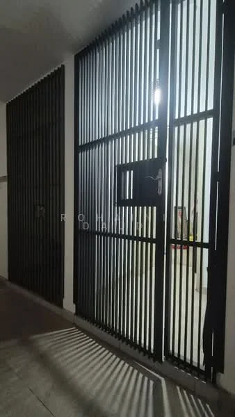Room features: black metal security gate, vertical slats, door with small window, concrete flooring, indirect lighting, neutral wall color, minimalist design; style: modern.