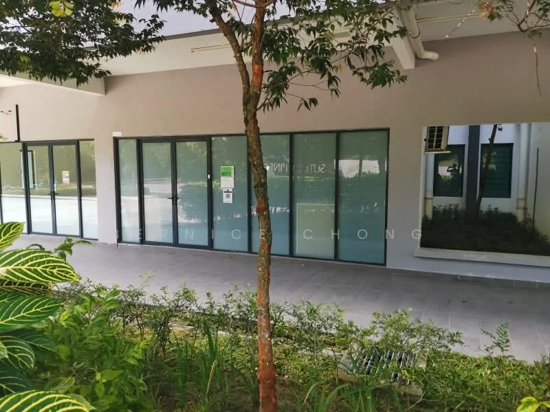 Exterior features: glass facade, greenery in front, paved walkway, landscaped area with plants, multiple glass doors, modern architectural design; style: modern.