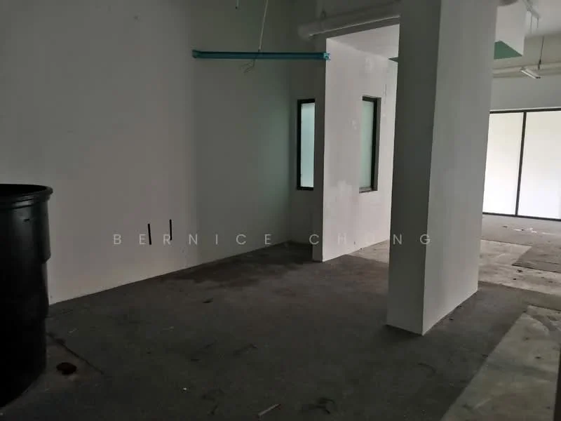 Room features: white painted walls, concrete flooring, two windows, exposed ceiling, suspended ceiling, blue overhead piping, empty space, no visible fixtures.