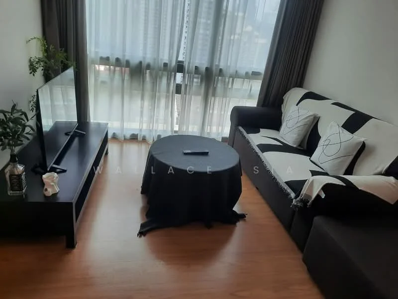 Living features: 3-seater fabric sofa in dark brown, black and white patterned throw pillows, black coffee table, TV console in black, wall-mounted TV, floor-to-ceiling windows with sheer curtains, wooden flooring, decorative plant in ceramic pot; style: modern; view: city.
