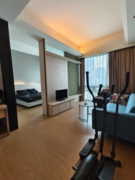 Living features: light wood flooring, grey accent wall, floor-to-ceiling windows, curtains, sofa in light blue, coffee table, wall-mounted TV, decorative cushions, decorative wall panel, recessed lighting, exercise equipment; style: modern; view: city. Bedroom features: queen-size bed, black bedding, bedside table, lamp, wall-mounted artwork; style: modern.