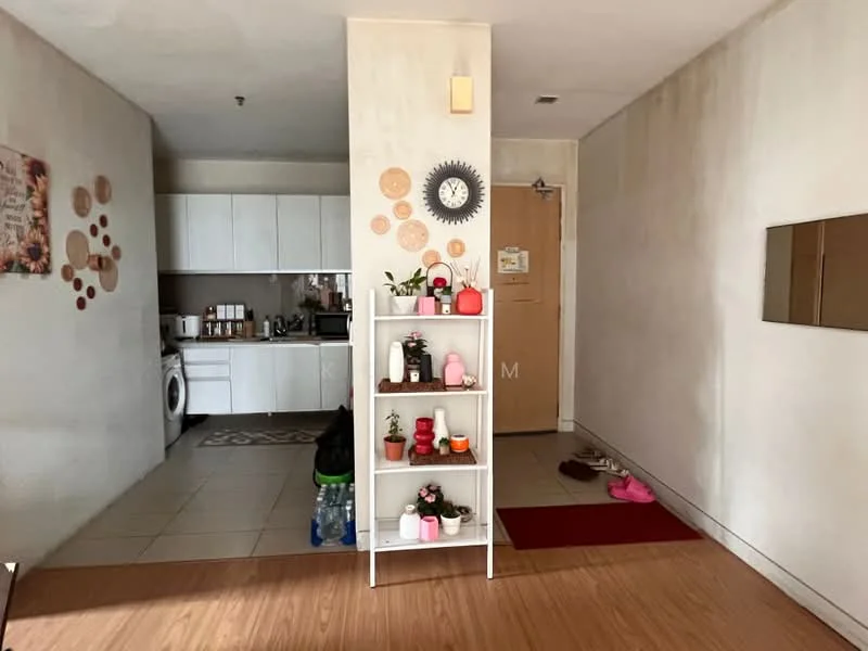 Room features: white painted walls, wooden flooring, tile flooring in kitchen area, open shelving unit with decorative items, wall clock, door with number plate, washing machine, kitchen cabinets, countertop, red area rug, shoes on the floor; style: modern.